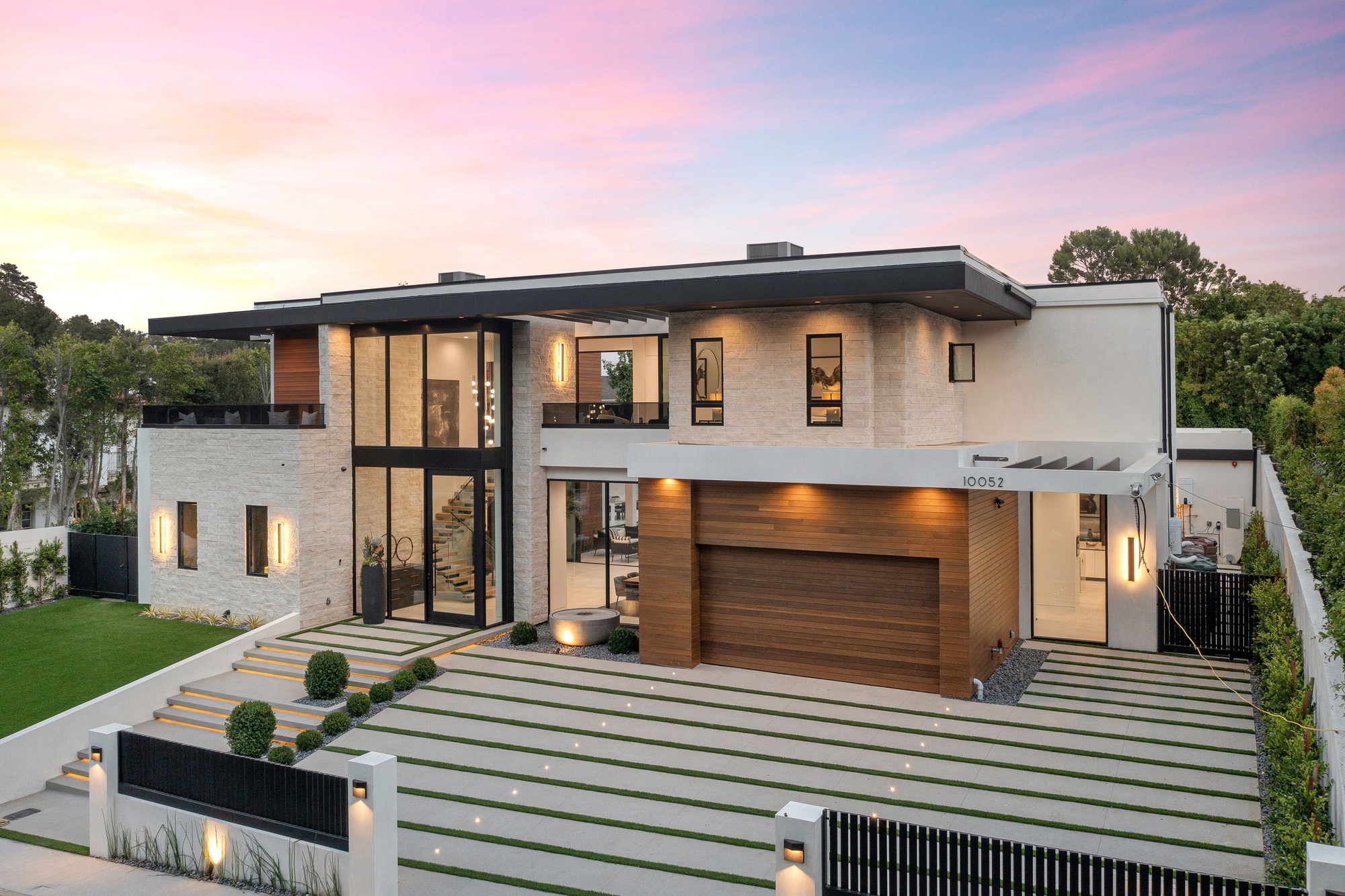 Modern luxury home exterior at sunset